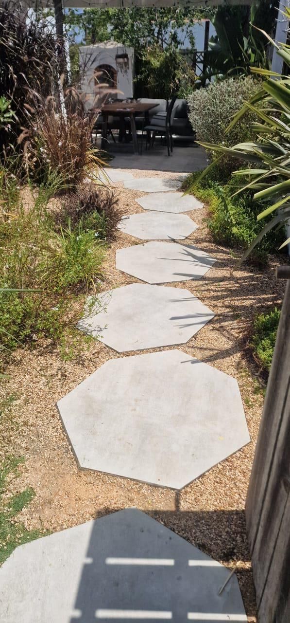 Stepping-stone path through a planted gravel garden